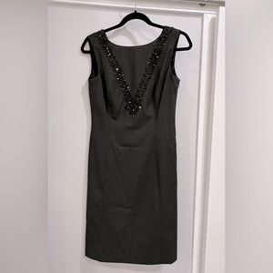 Dark gray dress with beading around collar and back. Back is a flattering ‘V’